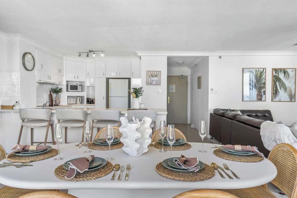 Gather for memorable meals around this beautifully set oval dining table, leading seamlessly into the open-plan modern kitchen and comfortable living room.