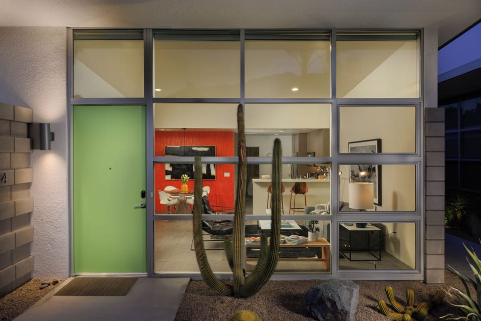 Architectural evening exterior showcasing dramatic glass walls