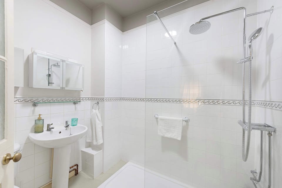 Located on the first floor, the shared family bathroom is bright, modern, and conveniently positioned to serve the three additional bedrooms. Complete with a shower, wash basin, and toilet, it provides a comfortable space for guests to refresh 