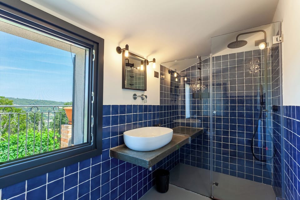 Double Room, Sea View | Bathroom | Shower, rainfall showerhead, hair dryer, slippers