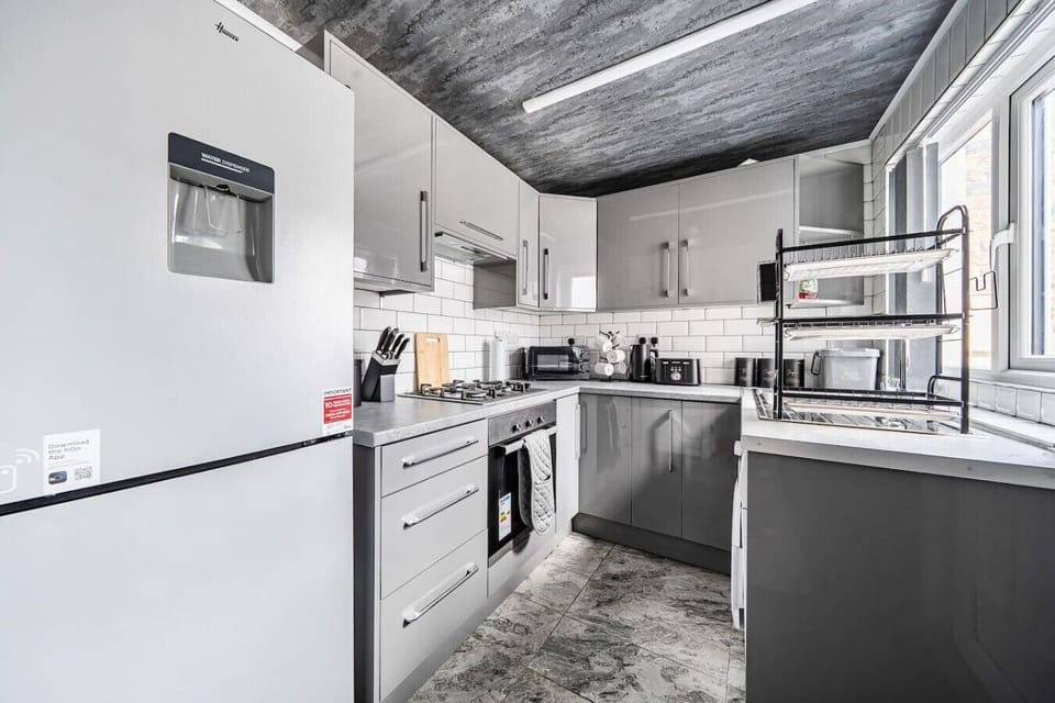 Sleek gray kitchen stocked with appliances for easy meal prep