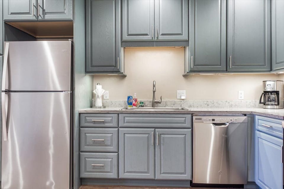 Modern kitchen with stainless appliances and stylish gray cabinetry