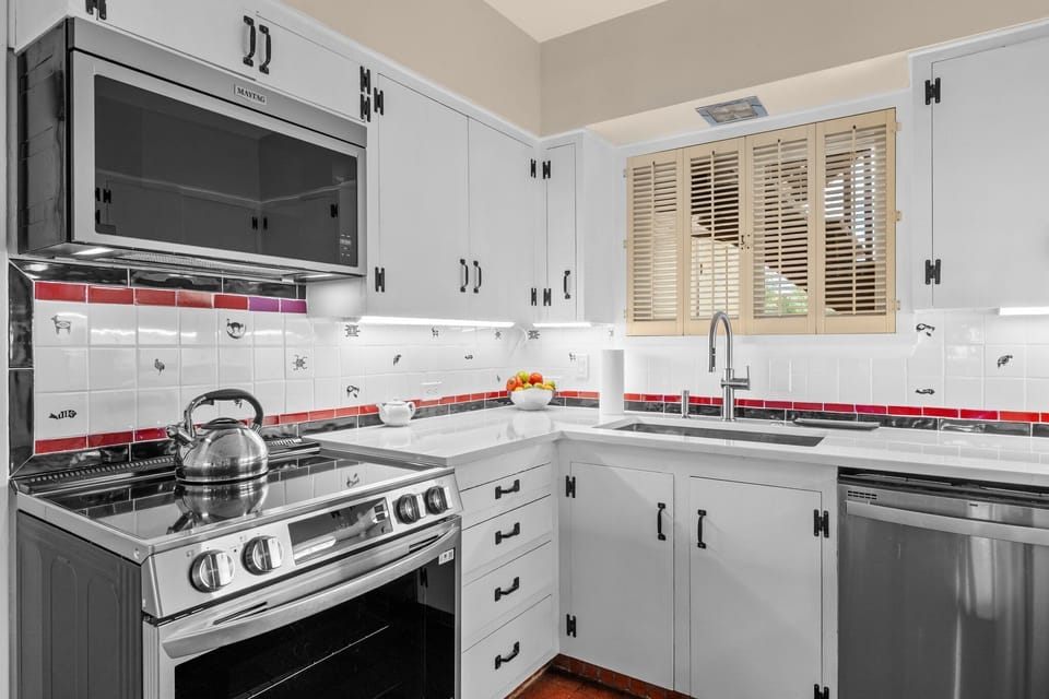 Bright updated kitchen with stainless appliances and stylish tile accents