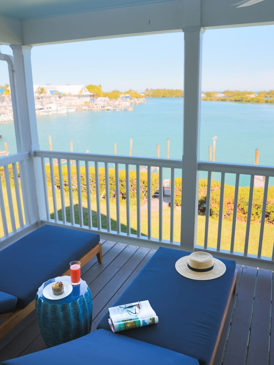 Unwind on the breezy balcony with a refreshing drink in hand, as you soak in panoramic views of the serene waters and charming docks below.
