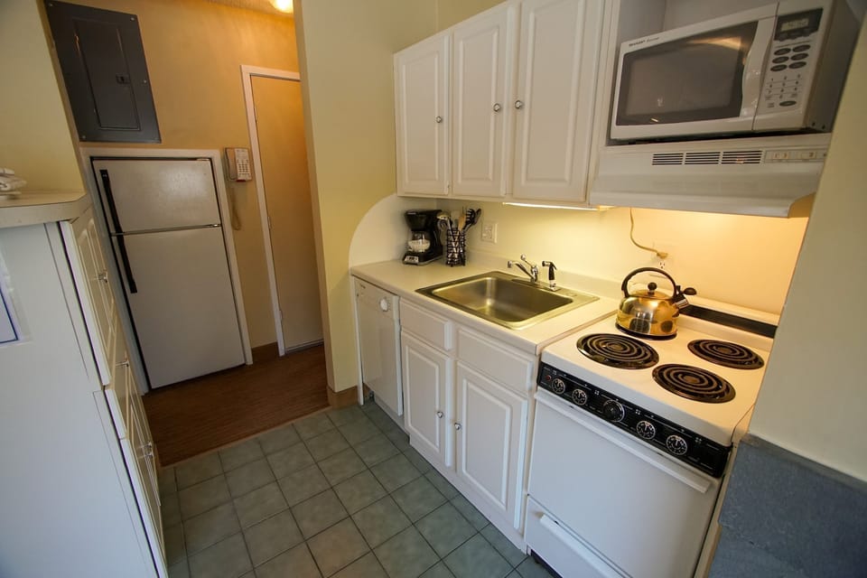 Bright and welcoming kitchen area with convenient appliances, perfect for your culinary adventures.