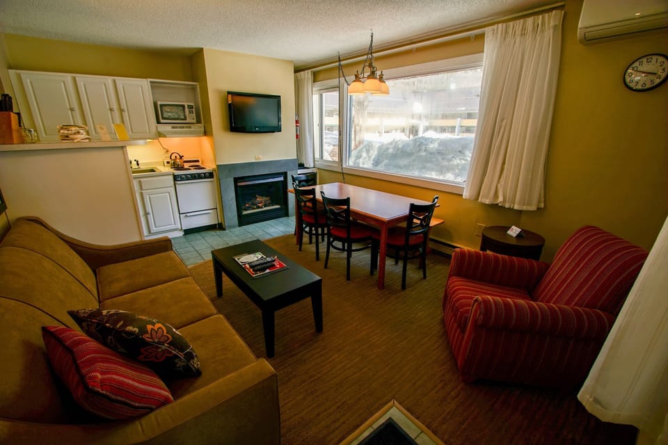 Cozy up by the fireplace, surrounded by comforts for a perfect evening in.