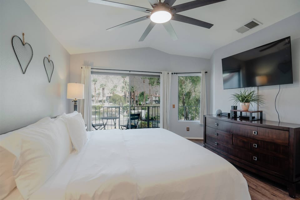 Master bedroom with King size bed, TV and balcony