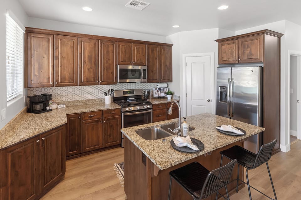 Full kitchen with island seating, plenty of counter space, and everything needed for easy meals at home.