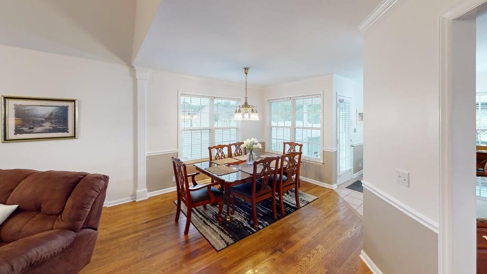 Formal dining area with seating for six, conveniently open to the living room 