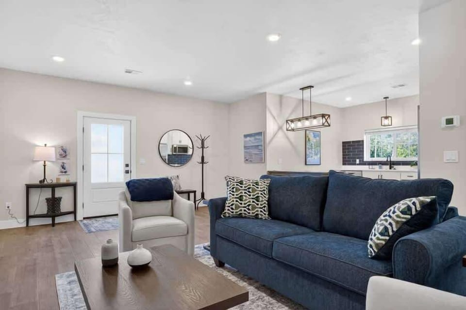 Unwind in your spacious living room with plush seating, modern lighting, and an open layout that flows seamlessly into the kitchen—perfect for relaxing after a day of adventure.