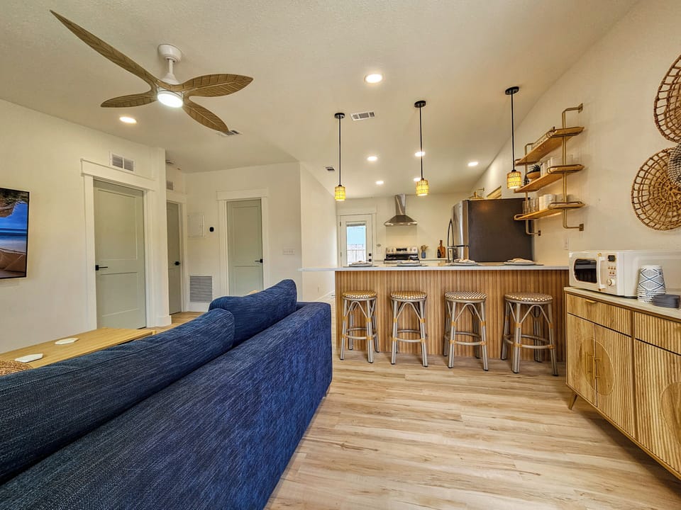 Open concept living with island seating for four.
