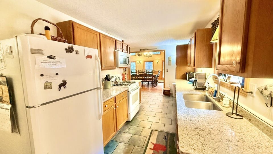 The fully equipped kitchen features modern appliances, ample counter space, and everything needed for preparing meals.