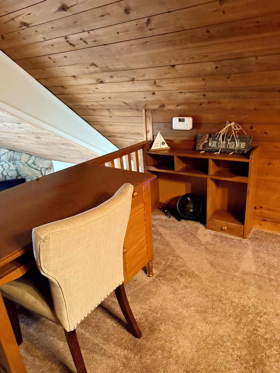Cozy loft office nook with wood paneling—ideal for WFH stays.