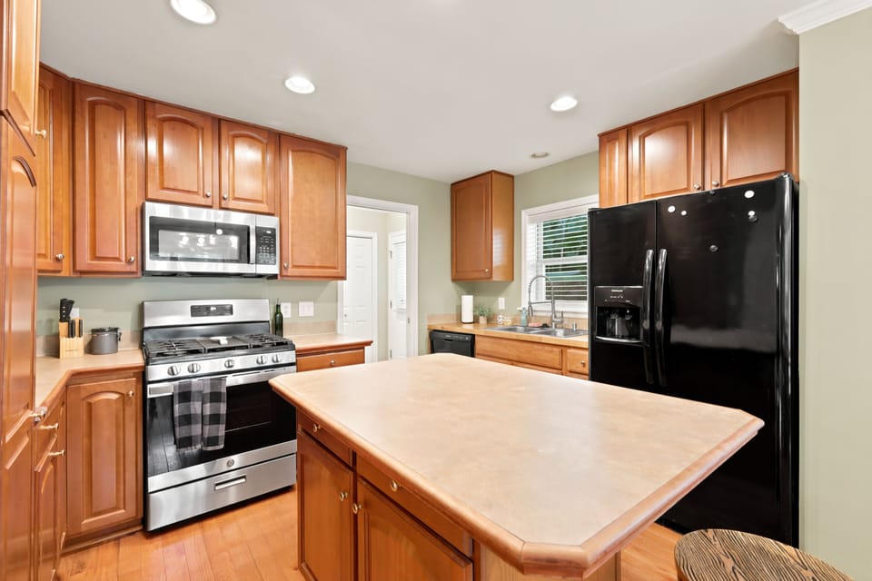 This bright kitchen is built for cooking together, with a large island for prepping and gathering, a gas range for whipping up big meals, and ample cabinet space to keep everything organized for the whole crew.