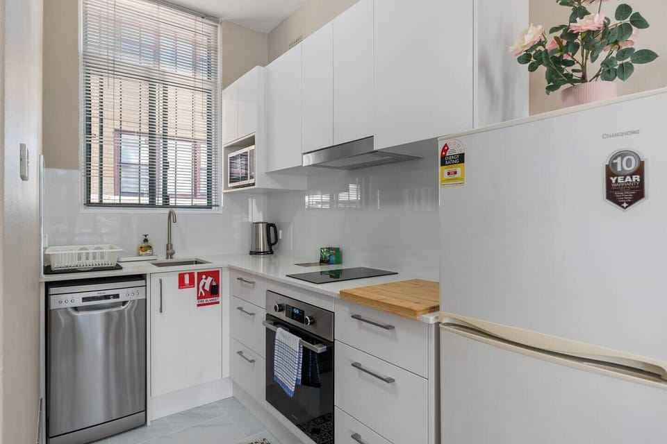 Prepare everything from a quick breakfast to a home-cooked dinner in the kitchen, where modern appliances and streamlined finishes make everyday cooking effortless.