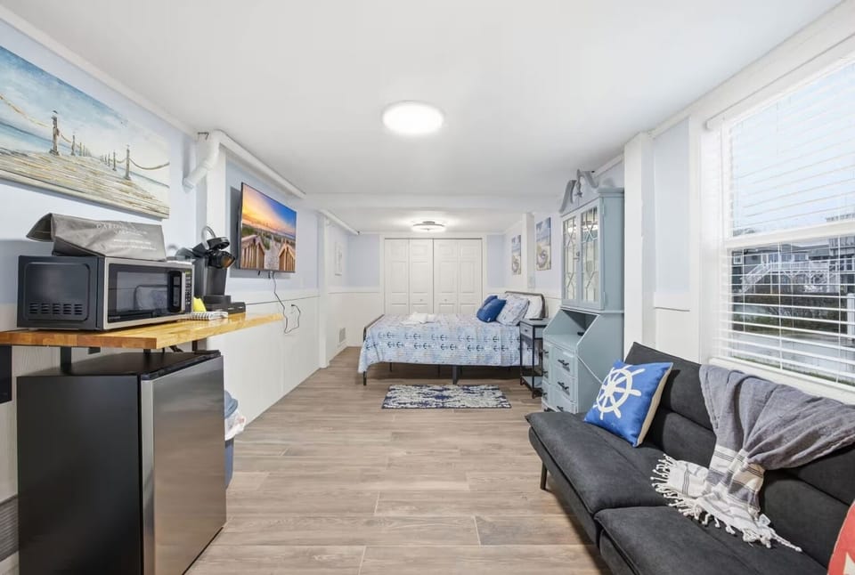 King bedroom featuring TV, coffee station, and lounge chair