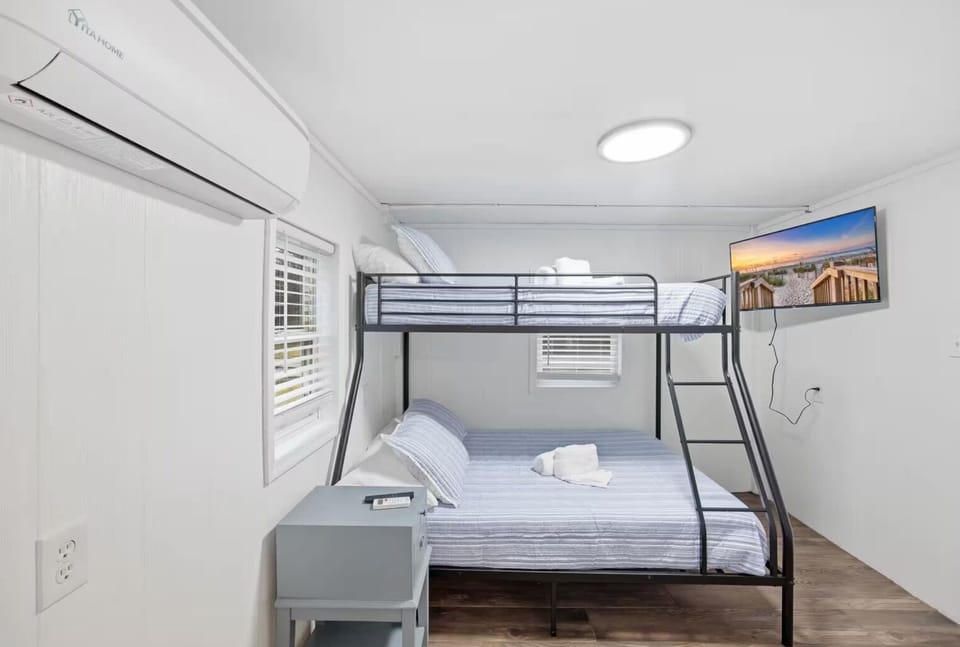 Spacious bunk room with a TV, perfect for kids or teenagers.