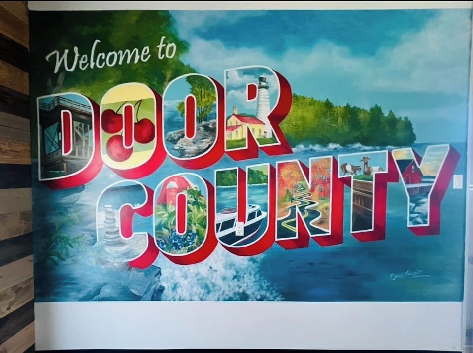 Vibrant Door County mural showcasing local destinations and scenic waterfront vibes
