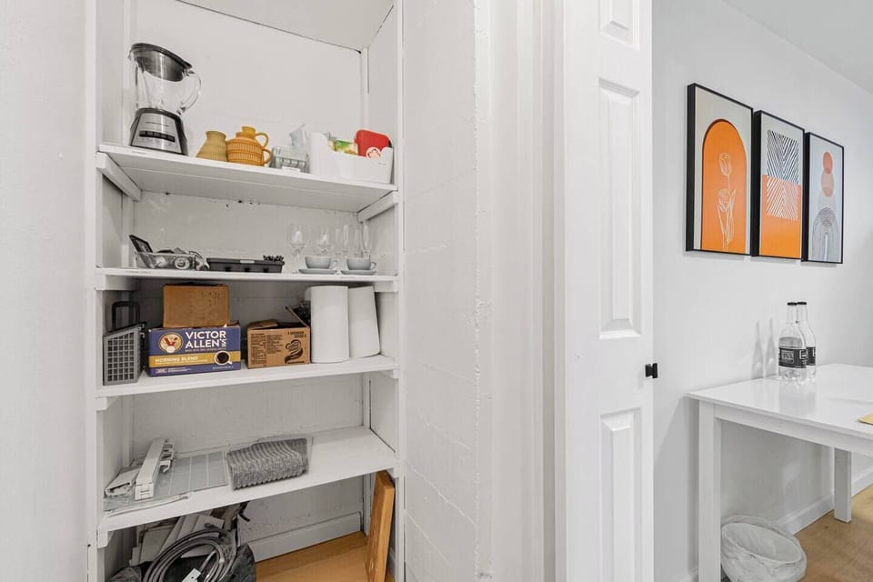 A well-stocked private pantry of the basement. Inside, you'll find an array of extra utensils and glasses, ensure you have everything you need for dining and entertaining. Also available are additional supplies of coffee and teas. 