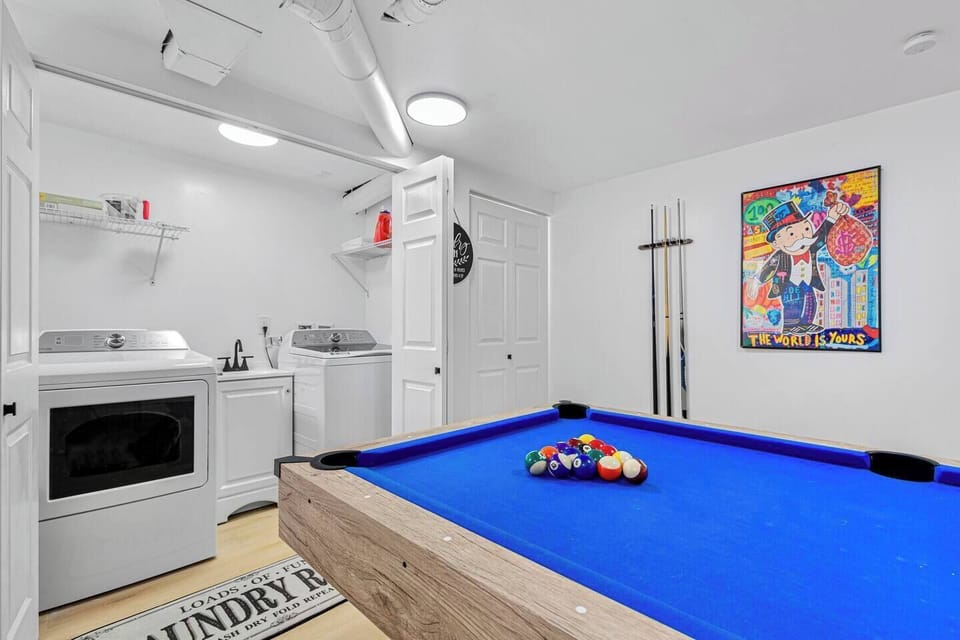 Adjacent to the pool table are the washer and dryer, available for guest use at no extra charge. 