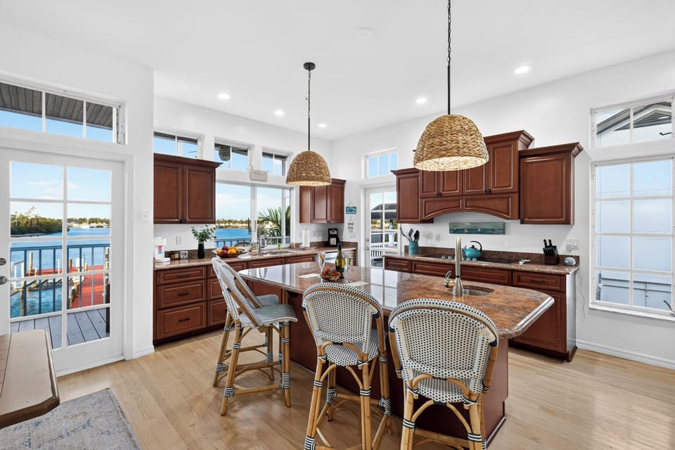The gourmet kitchen boasts a massive granite-top center island with breakfast bar seating.