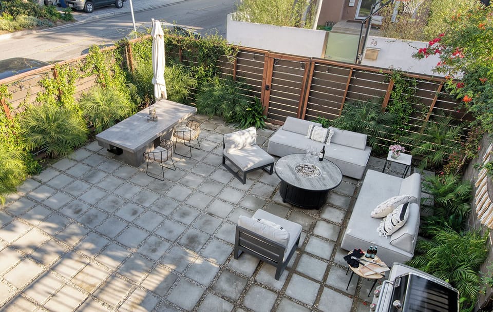 High-angle view of the beautifully paved, private courtyard featuring multiple seating and dining arrangements.