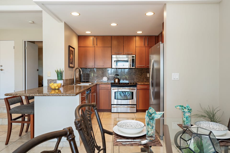 Fully equipped kitchen flowing into the dining area for easy meals together.