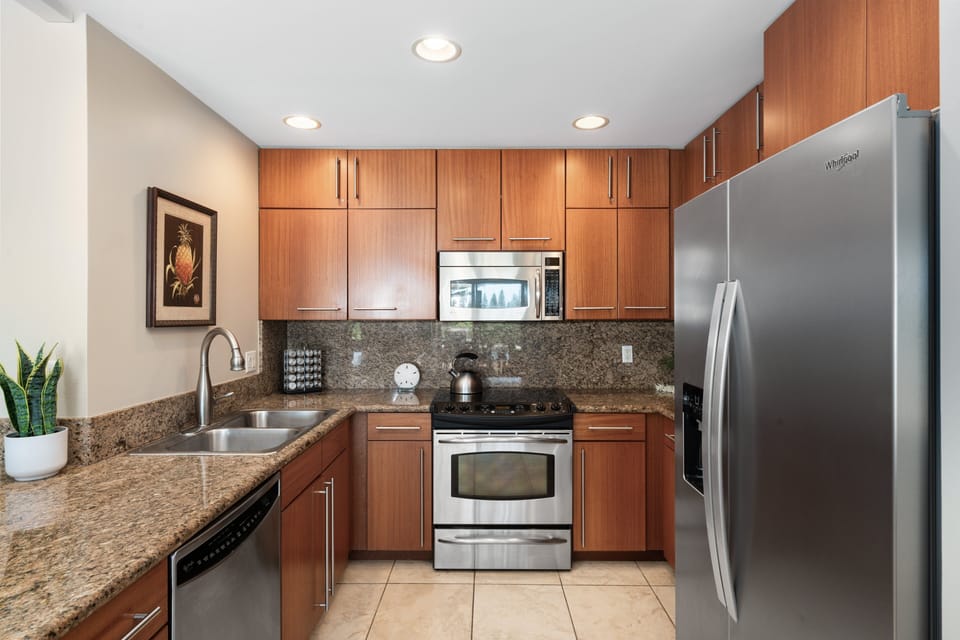 Fully equipped kitchen with stainless appliances and ample counter space.