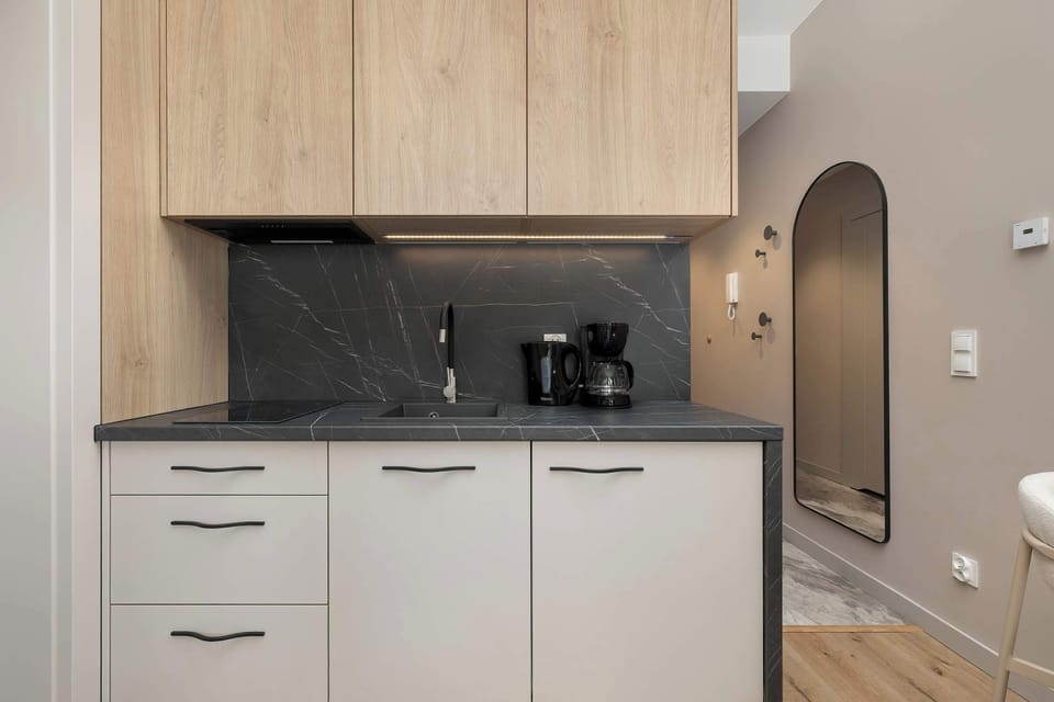 The sleek design of the kitchenette blending seamlessly with the living area.