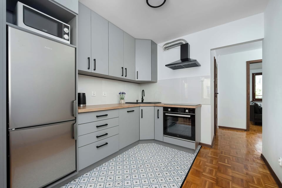 The kitchen's sleek design includes all necessary cookware and utensils.