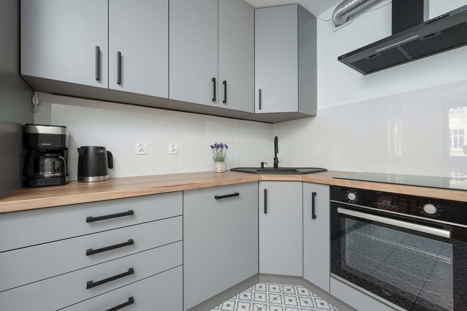 The kitchen's contemporary decor complements the apartment's style.