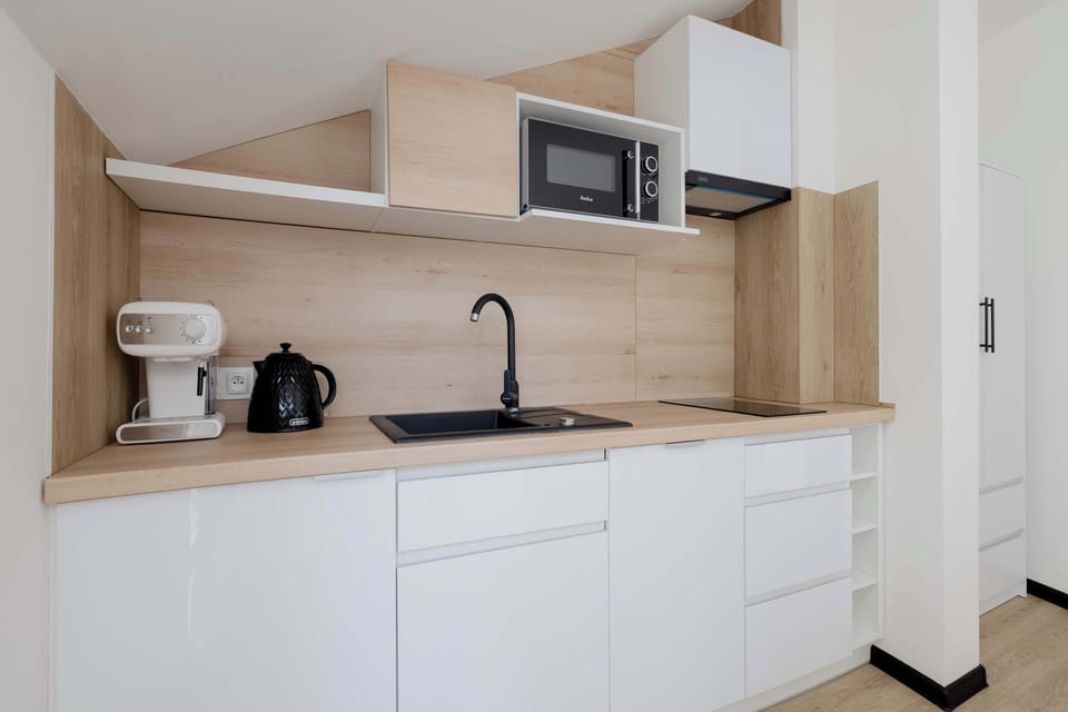 The sleek design of the kitchenette blending seamlessly with the living area.