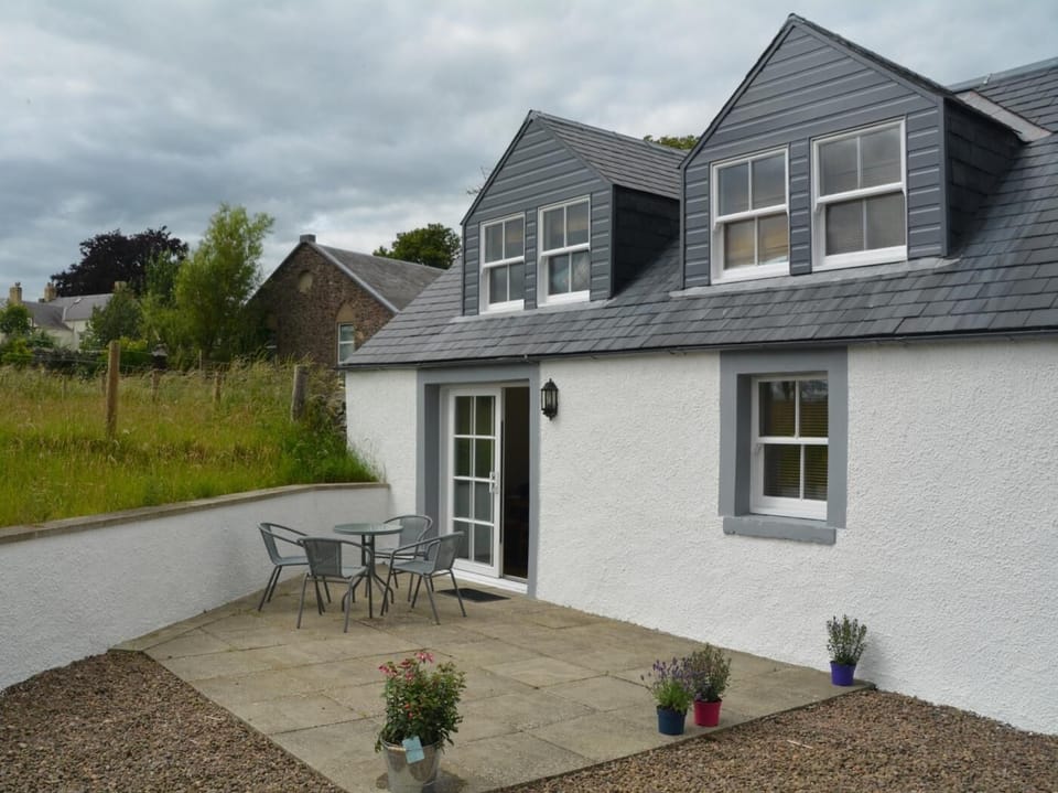 View towards the rear of the property with seating area, perfect for alfresco dining