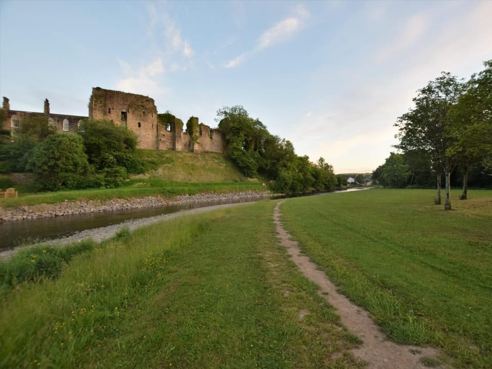 The castle, with Jennings brewery nestled beneath