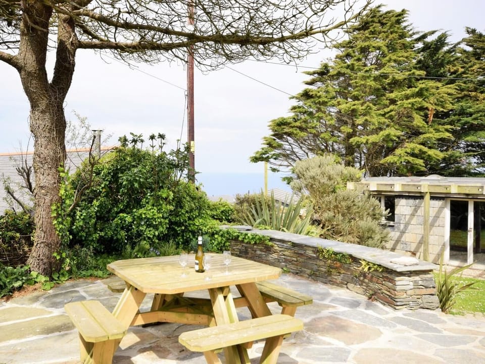 Sit back on the patio looking over countryside and out to sea