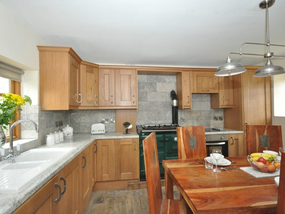 A traditional farmhouse kitchen with warming Rayburn