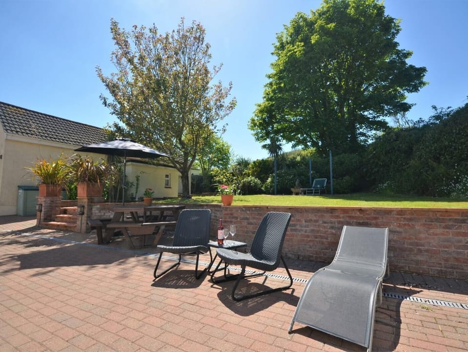 Spacious grounds with patio, garden furniture and lawns
