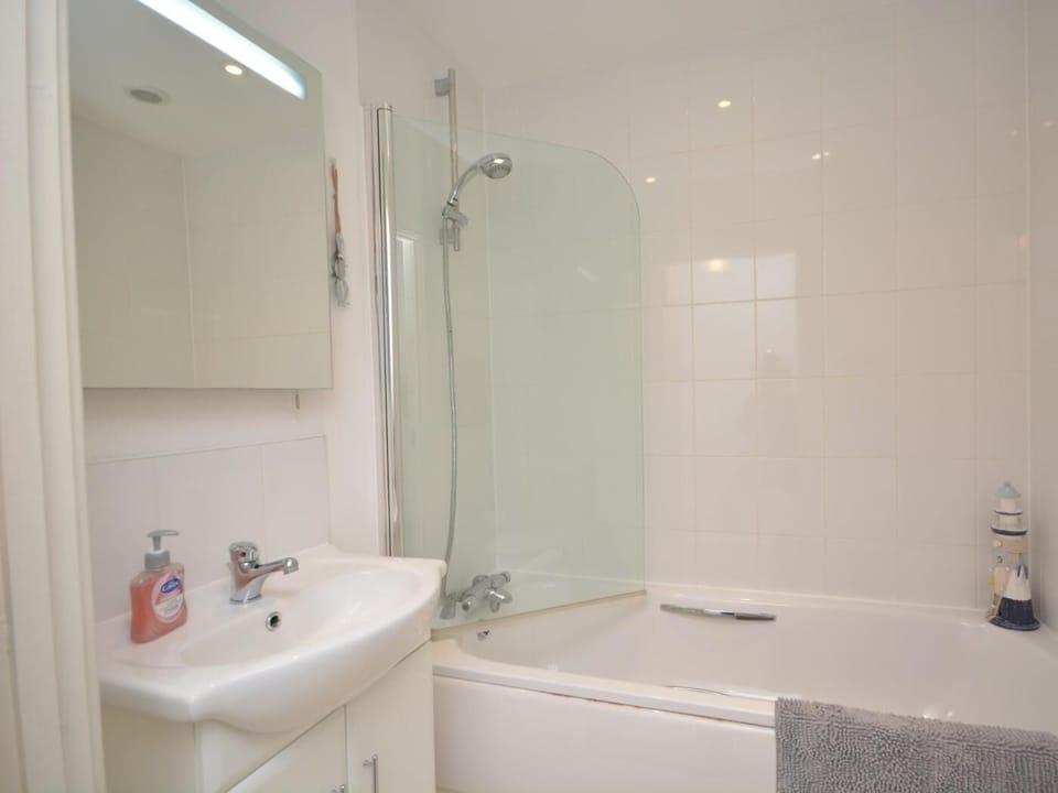 Bathroom with shower over bath and WC