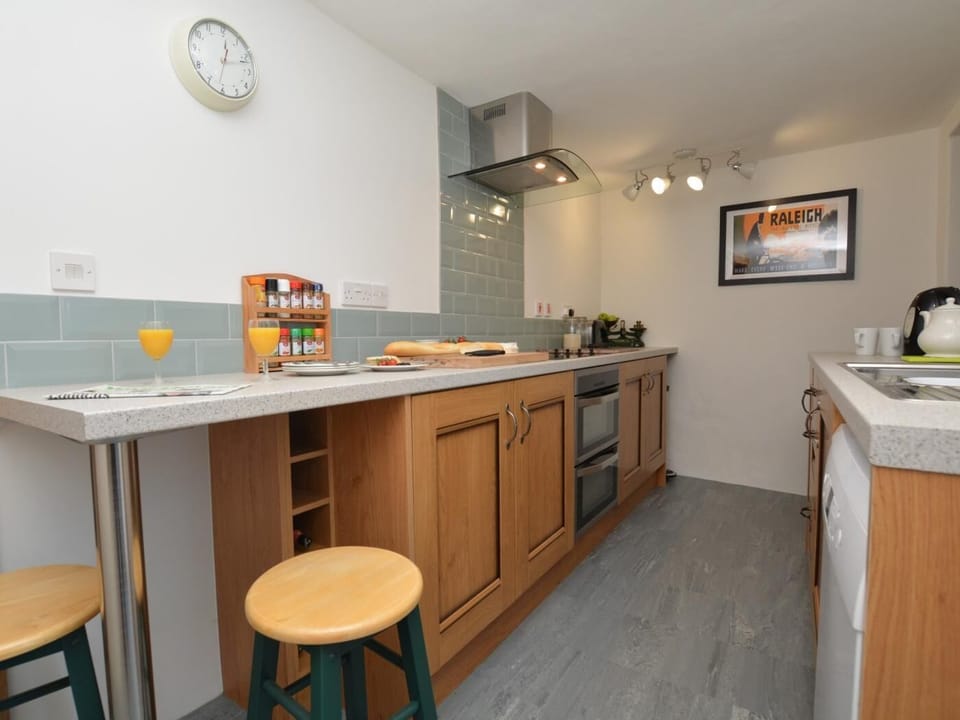 Stylish galley kitchen with small breakfast bar