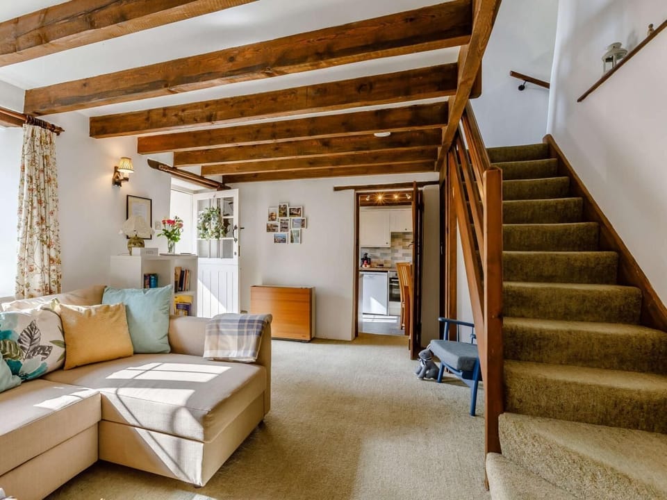 The main lounge with stairs leading to upper floor.