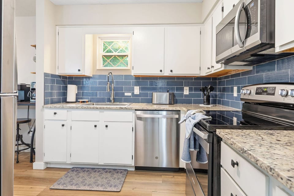 Kitchen w/ fridge, dishwasher, and oven - stocked with all the cooking essentials