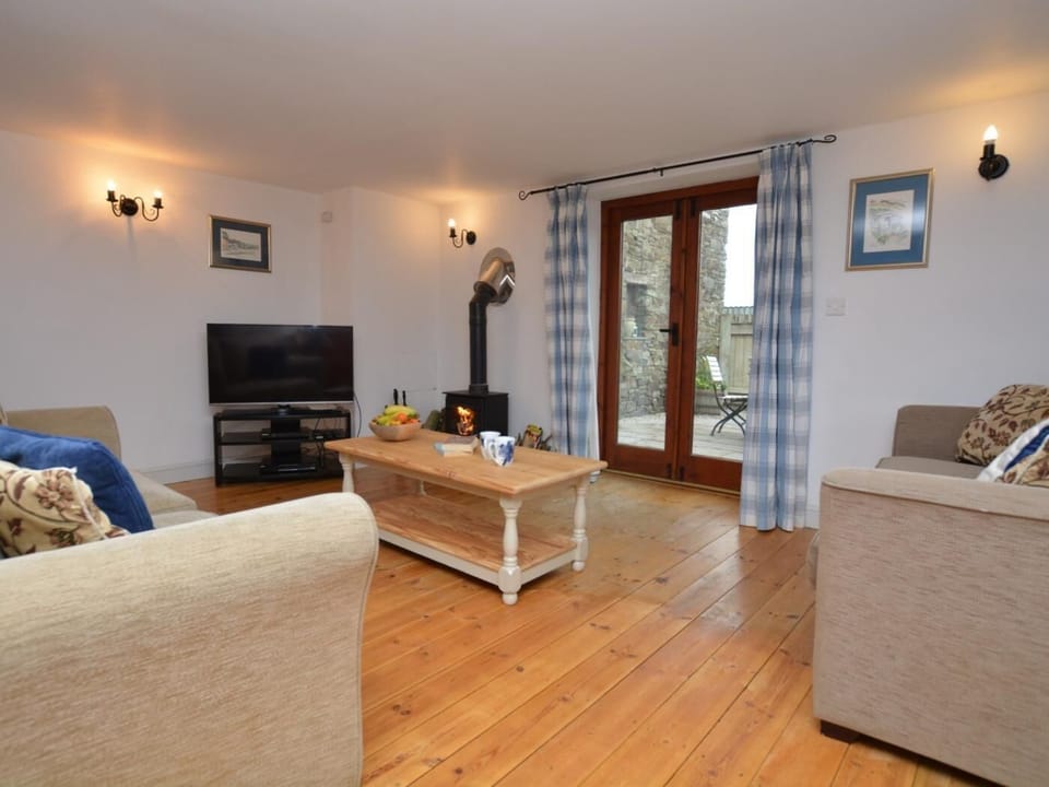 Lounge with wood burner and French doors leading to the courtyard