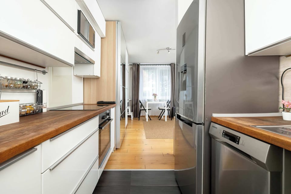 The sleek design of the kitchenette blending seamlessly with the living area.