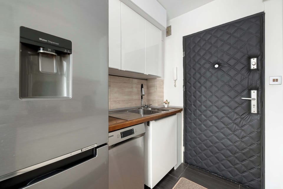 The kitchenette's modern design fits perfectly with the living area.