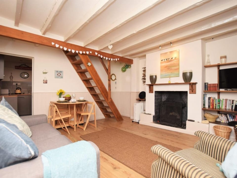 Lounge/dining area with fireplace and exposed beams