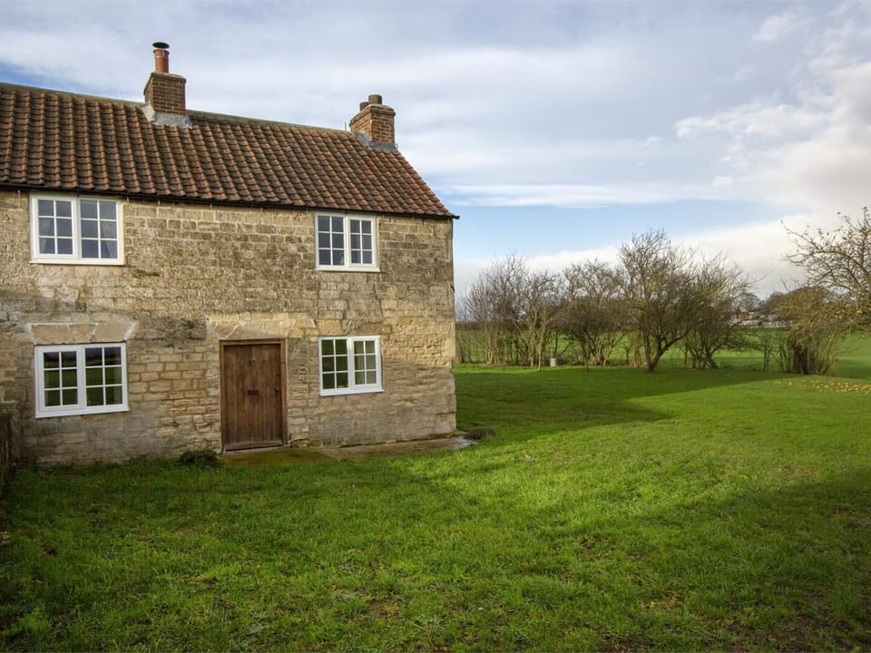 Extensive grounds wait to be explored, including an enclosed orchard filled with lush fruit trees