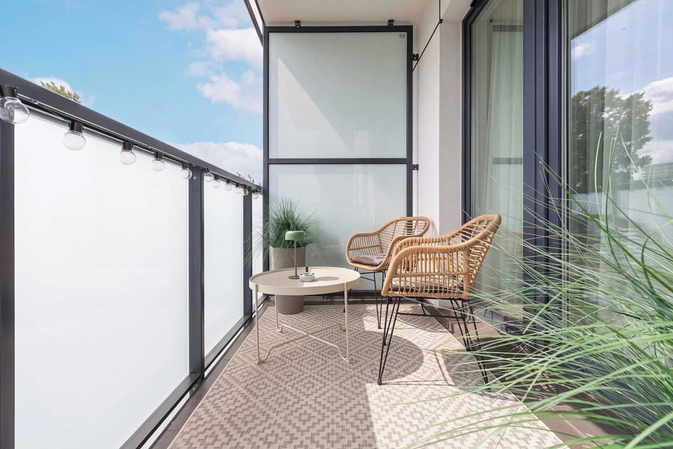 A relaxing view from the balcony with outdoor seating. It's a lovely place to enjoy fresh air at any time of day.