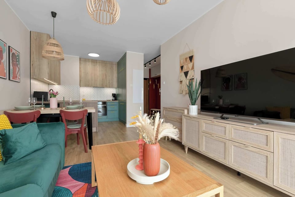 A wide view of the living room and fully equipped kitchenette. The bright interior offers everything you need for a comfortable stay.