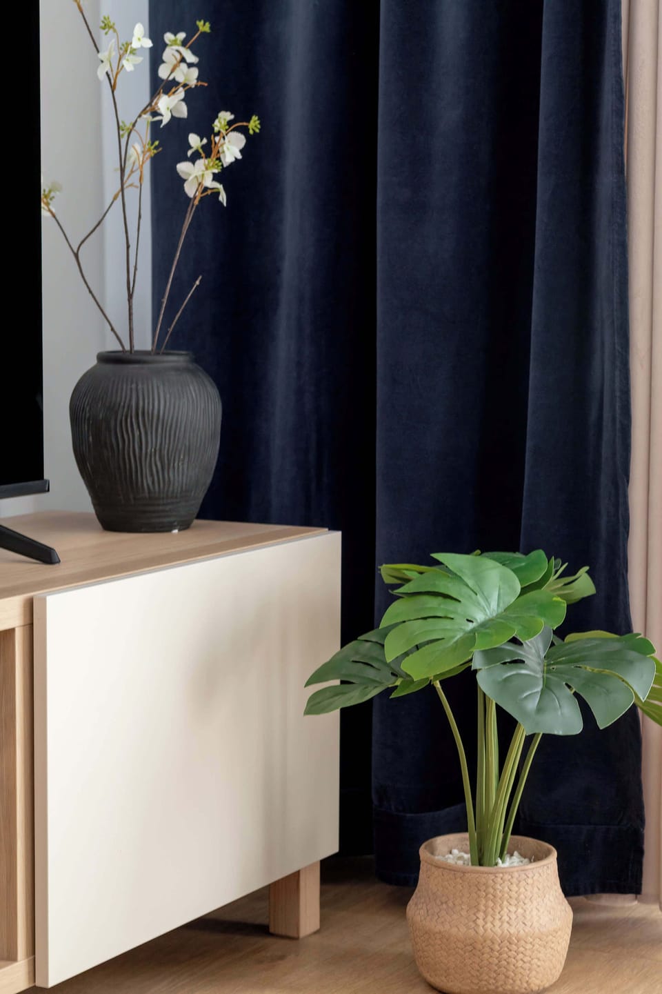 A stylish dresser decorated with elegant flowers and modern accents. Thoughtful details create a warm and welcoming atmosphere.