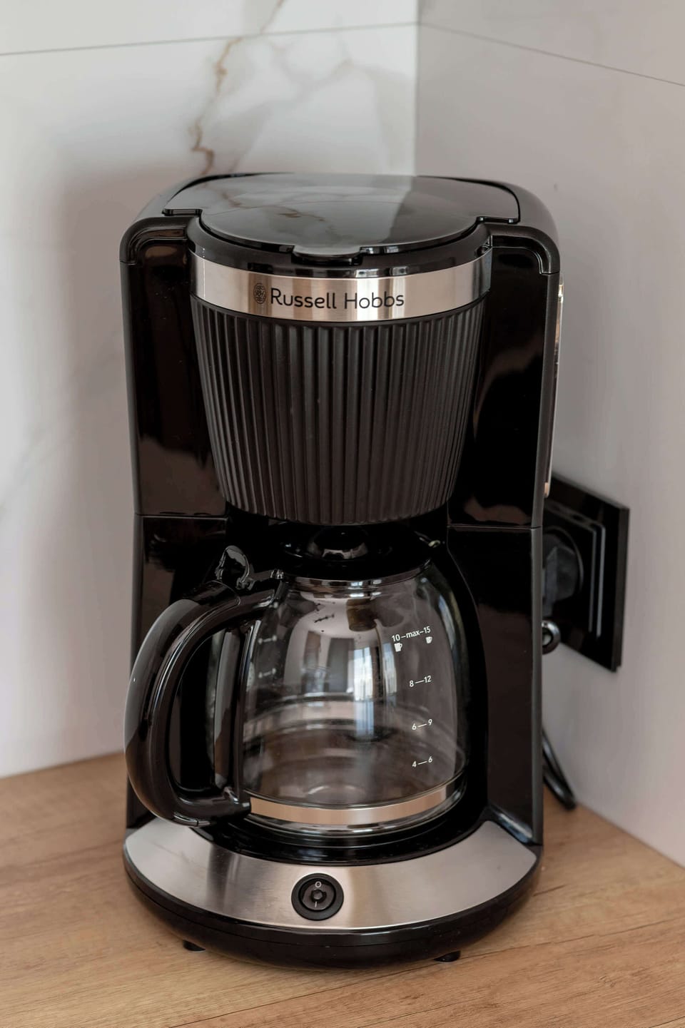 A coffee maker ready to prepare your favorite hot drinks. Enjoy fresh coffee from the comfort of your apartment.